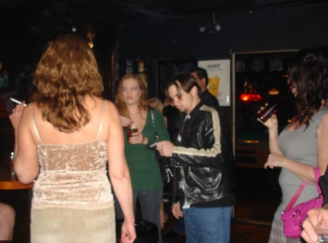 Sexy amateur wives show off their big tits and pussies at a nightclub