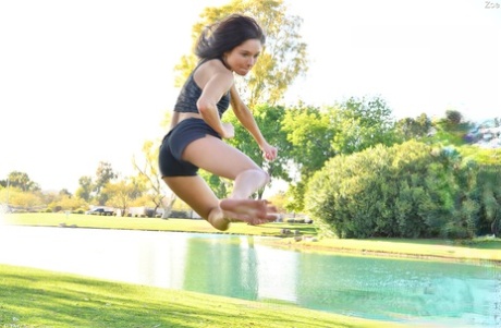 Teenage hottie in sexy outfit Zoe doing exercise outdoors by the water