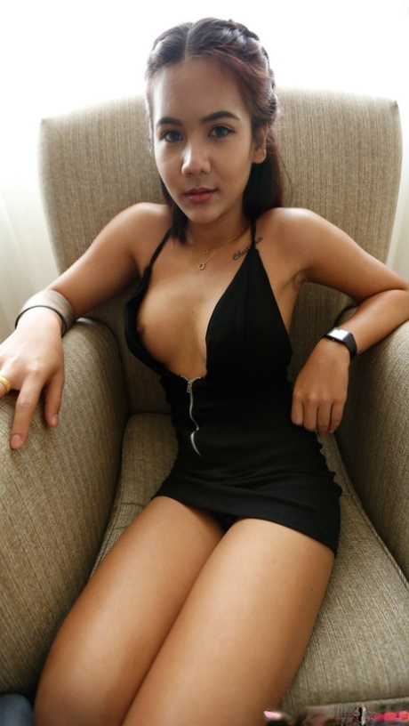 Brunette Asian teen Tess B shows her big tits and poses in a hotel room