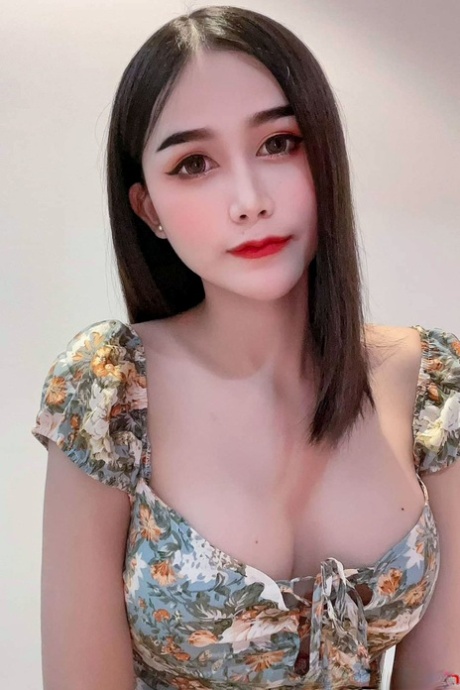 Attractive Asian shemale Bella shows her cleavage in her solo compilation