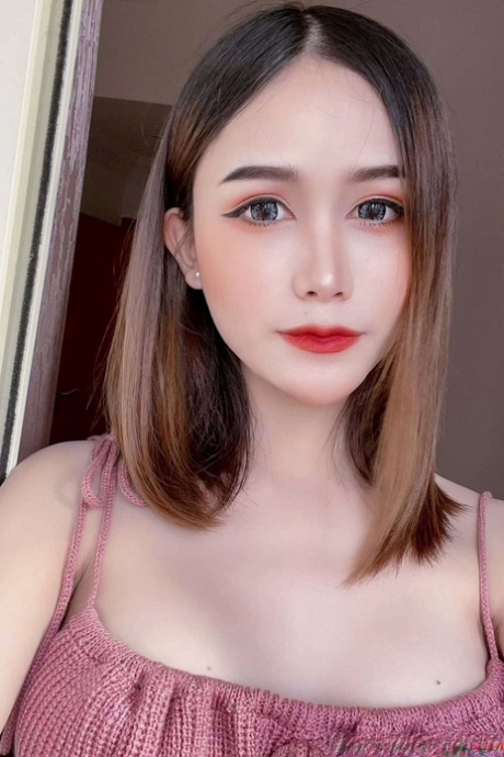 Attractive Asian shemale Bella shows her cleavage in her solo compilation