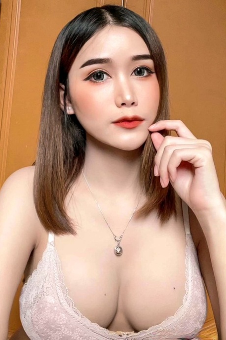 Attractive Asian shemale Bella shows her cleavage in her solo compilation