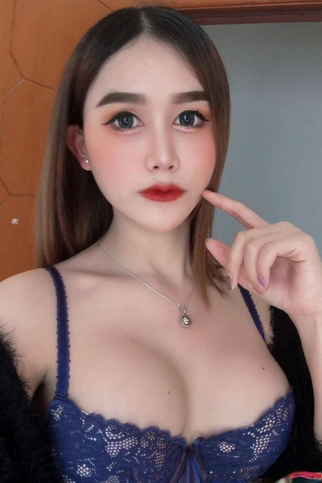 Attractive Asian shemale Bella shows her cleavage in her solo compilation