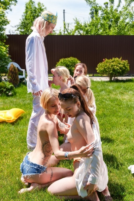Slutty babes give each other a pussy licking in a wild outdoor orgy