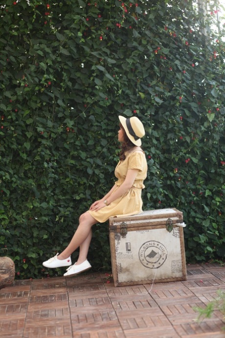 Lovely Asian model posing in her summer dress and white shoes in public